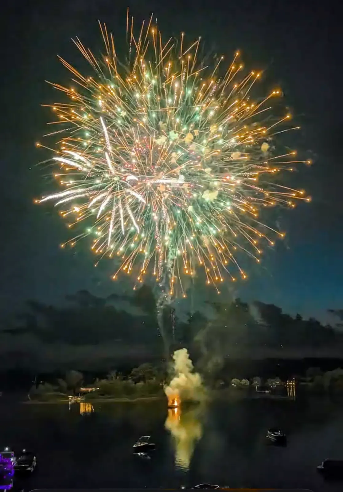 Fireworks over a lake at night